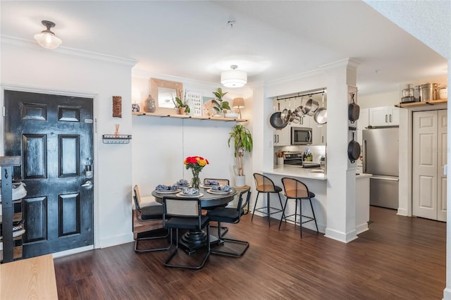 dining space featuring ornamental molding and dark hardwood / wood-style floors