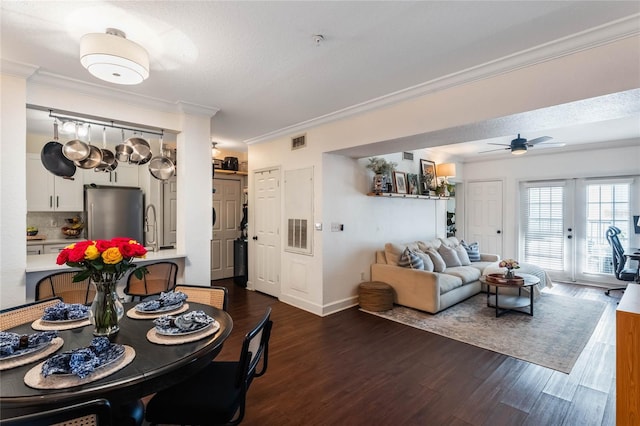 dining area featuring ceiling fan, dark hardwood / wood-style floors, french doors, a textured ceiling, and ornamental molding