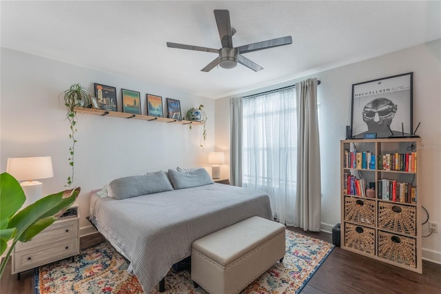 bedroom with ceiling fan and dark hardwood / wood-style flooring