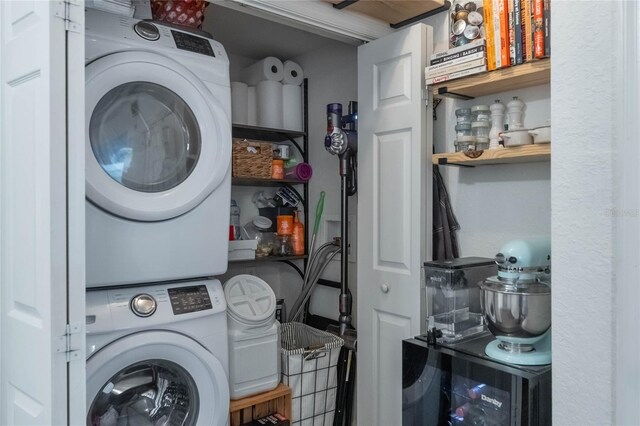 laundry room featuring stacked washer and clothes dryer