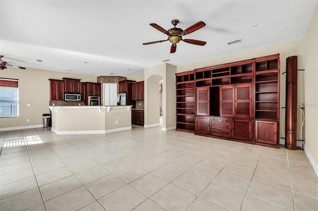 unfurnished living room with ceiling fan and light tile patterned floors