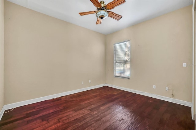 empty room with dark wood-type flooring and ceiling fan