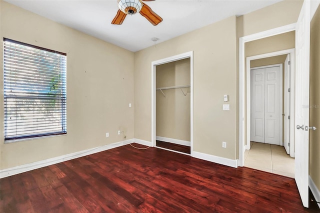 unfurnished bedroom featuring ceiling fan and dark hardwood / wood-style flooring