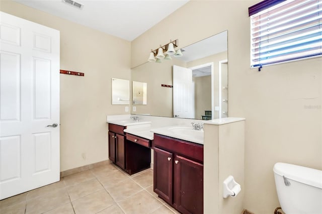 bathroom featuring toilet, tile patterned flooring, and vanity