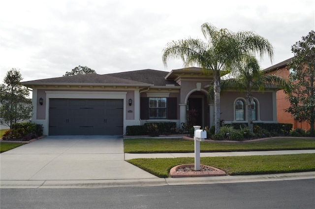 view of front of home featuring a garage and a front yard