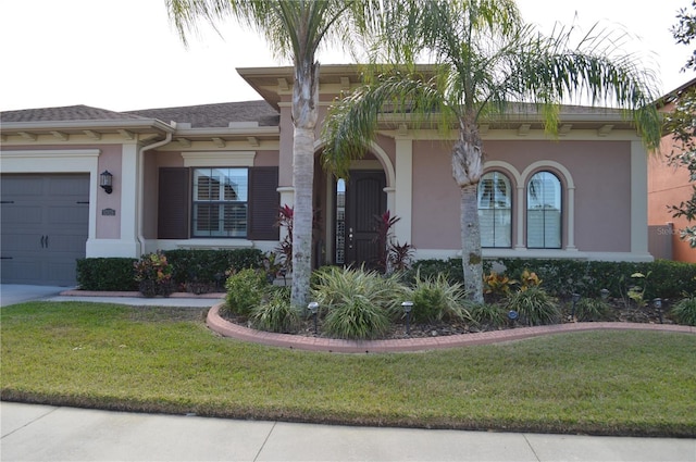 view of front of house featuring a garage and a front lawn