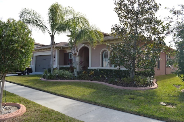 view of front of home with a front lawn and a garage