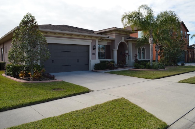 view of front of home featuring a front lawn and a garage