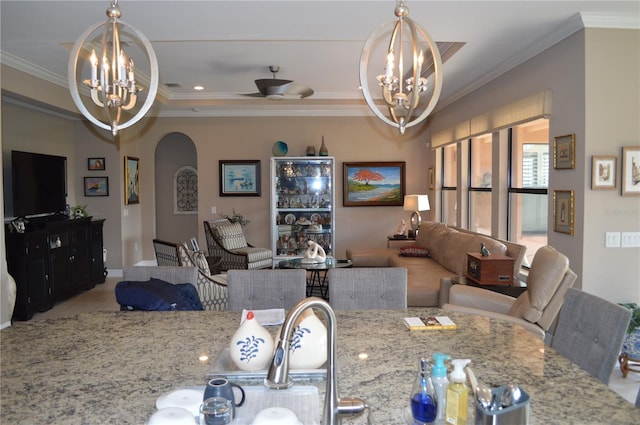 dining room with ceiling fan with notable chandelier and ornamental molding