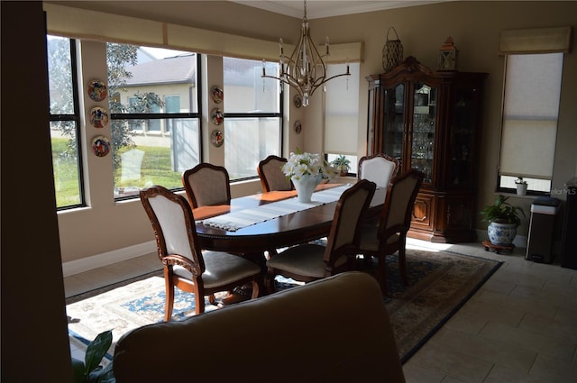 tiled dining space with an inviting chandelier, crown molding, and plenty of natural light