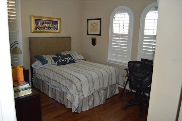 bedroom with dark wood-type flooring