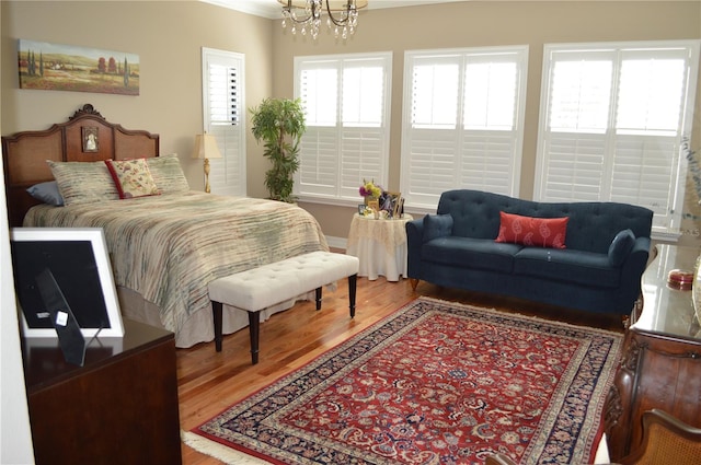 bedroom featuring hardwood / wood-style floors and a notable chandelier