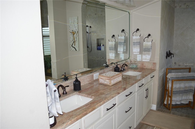 bathroom with vanity and a tile shower