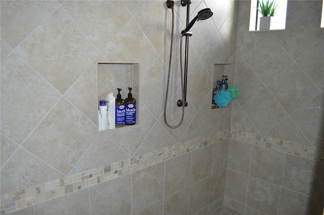 bathroom with a tile shower