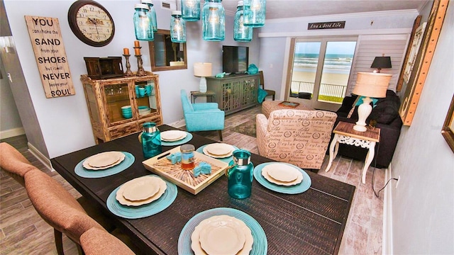 dining area featuring crown molding and hardwood / wood-style floors