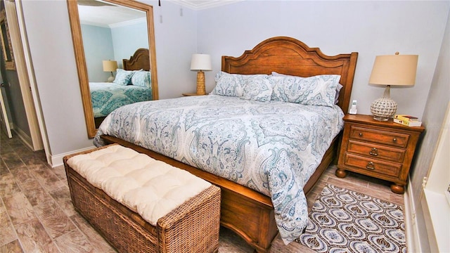 bedroom featuring crown molding and hardwood / wood-style floors