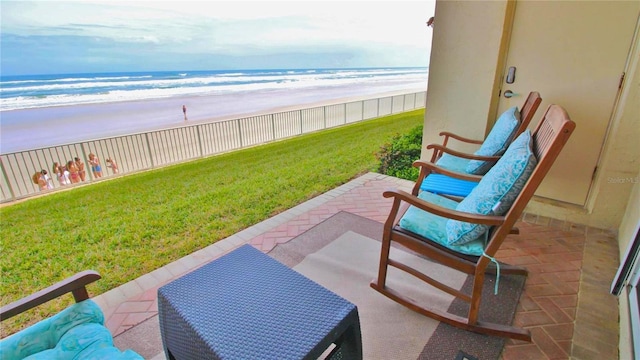 view of patio featuring a water view and a view of the beach