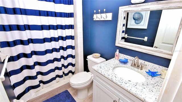 bathroom featuring curtained shower, toilet, and vanity