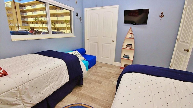 bedroom featuring light hardwood / wood-style flooring and a closet