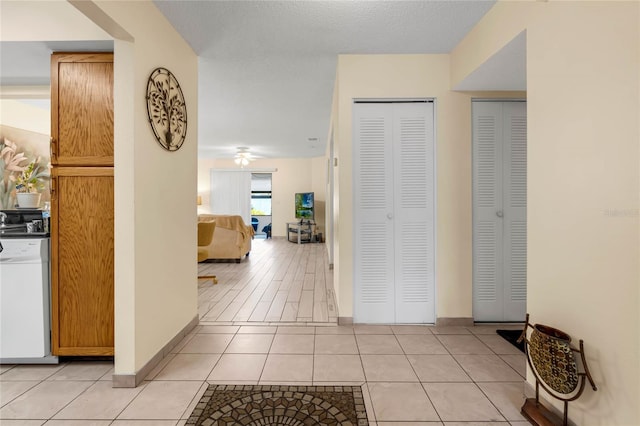 hall featuring light tile patterned floors