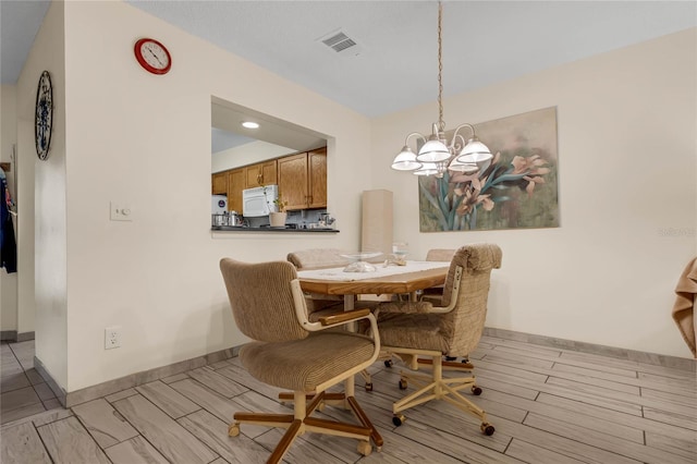 dining space with a chandelier