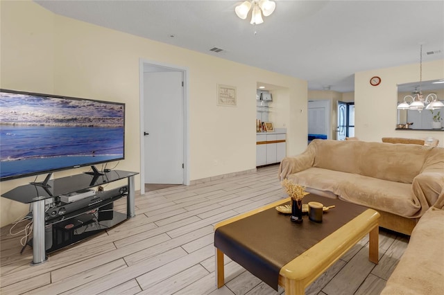 living room with ceiling fan with notable chandelier