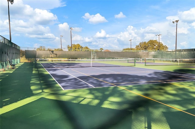 view of tennis court with basketball hoop