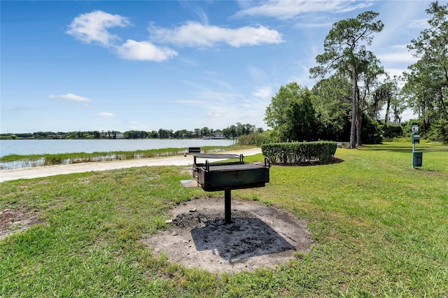 view of property's community featuring a yard and a water view