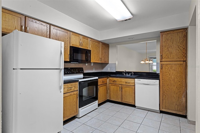 2923 Marshfield Ct Unit Ge, Orlando, FL 32822 - kitchen featuring black appliances, a chandelier, dark countertops, a sink, and light tile patterned floors