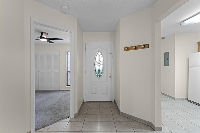 2923 Marshfield Ct Unit Ge, Orlando, FL 32822 - foyer entrance featuring a textured ceiling, a ceiling fan, light tile patterned floors, electric panel, and baseboards