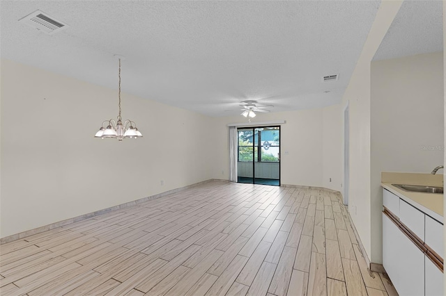 2923 Marshfield Ct Unit Ge, Orlando, FL 32822 - unfurnished dining area featuring a sink, a ceiling fan, a textured ceiling, light wood-style floors, and a chandelier