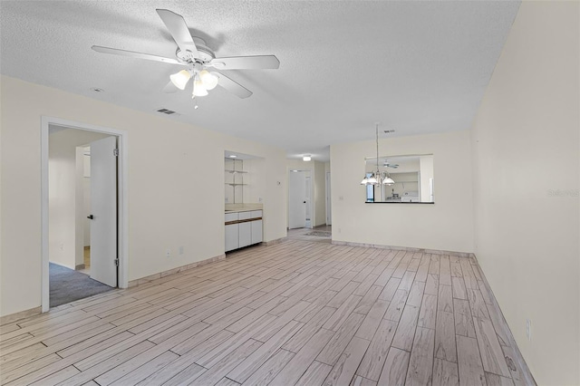 2923 Marshfield Ct Unit Ge, Orlando, FL 32822 - unfurnished living room with light wood-style flooring, a ceiling fan, a chandelier, a textured ceiling, and baseboards