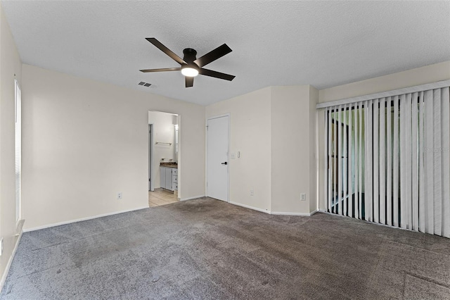 2923 Marshfield Ct Unit Ge, Orlando, FL 32822 - empty room featuring ceiling fan, carpet floors, baseboards, and a textured ceiling