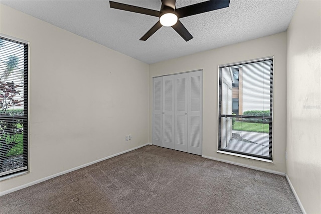 2923 Marshfield Ct Unit Ge, Orlando, FL 32822 - unfurnished bedroom featuring carpet flooring, a textured ceiling, a closet, ceiling fan, and baseboards