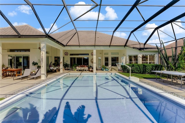 view of swimming pool with a lanai and a patio area