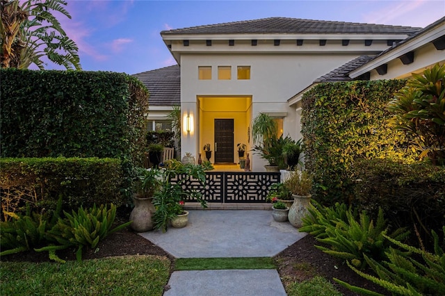 view of exterior entry at dusk