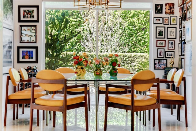 dining room featuring an inviting chandelier and a healthy amount of sunlight