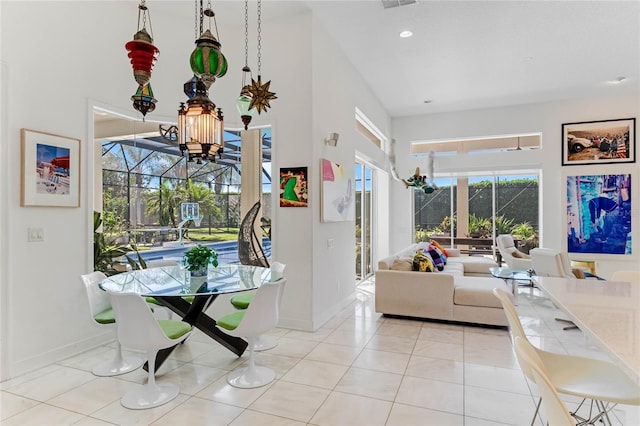 living room with a towering ceiling and light tile patterned flooring