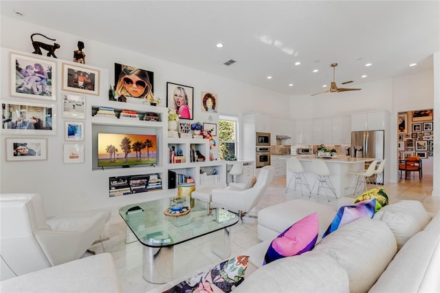 living room with ceiling fan and light tile patterned floors