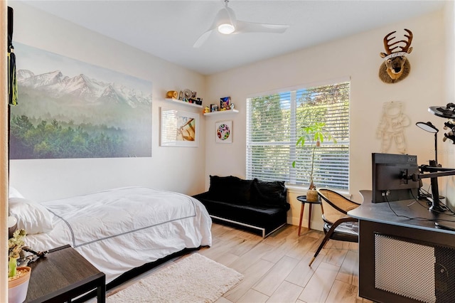 bedroom with ceiling fan and light hardwood / wood-style floors