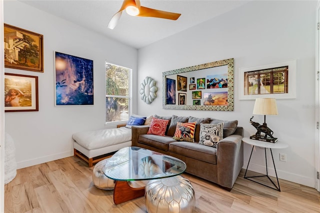 living room with ceiling fan and light hardwood / wood-style flooring