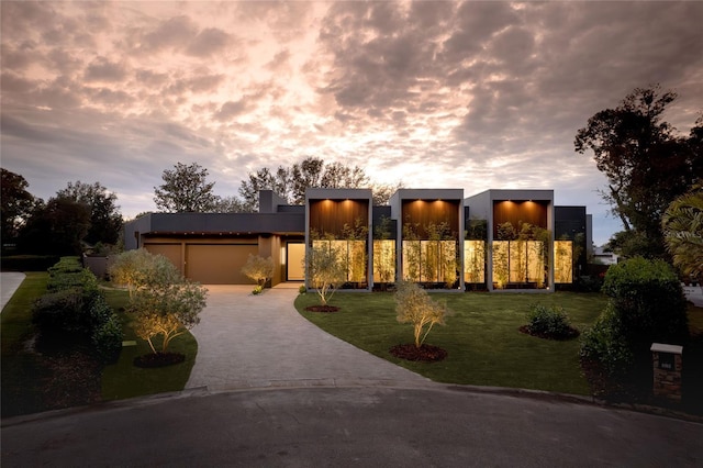 contemporary house with a garage and a yard