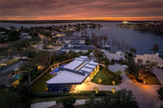 aerial view at dusk with a water view