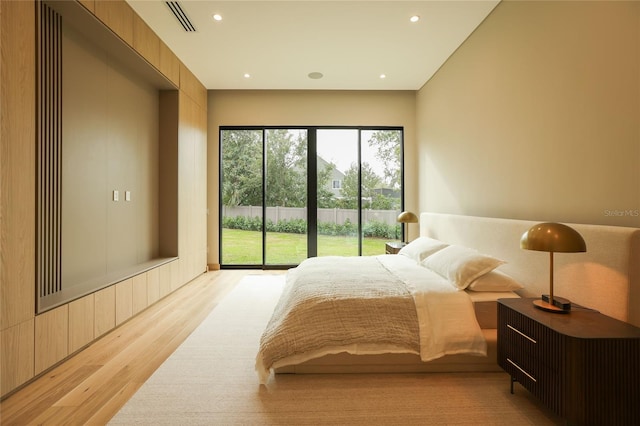 bedroom with access to outside and light hardwood / wood-style floors