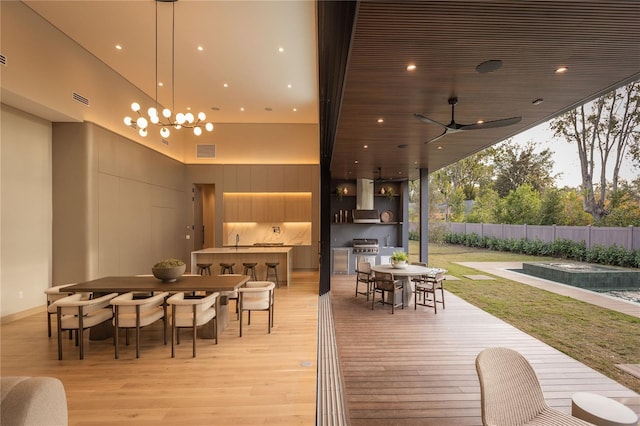 exterior space featuring ceiling fan, an outdoor kitchen, and sink