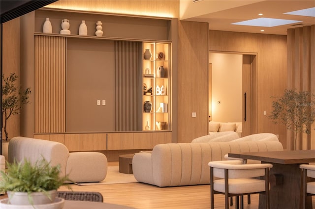 interior space with a skylight and wood walls