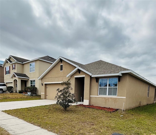 view of front facade featuring a garage and a front lawn