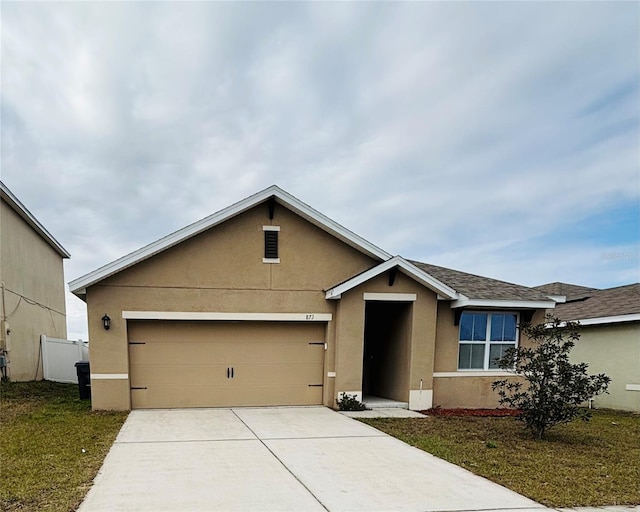 view of front of house with a garage and a front yard