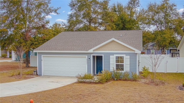 view of front of property featuring a garage and a front lawn