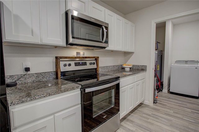 kitchen featuring washer / dryer, white cabinets, and appliances with stainless steel finishes